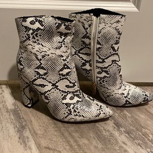 Black and white snake skim boots.